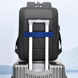 Sac à dos ordinateur fixé sur une valise grâce à sa sangle trolley